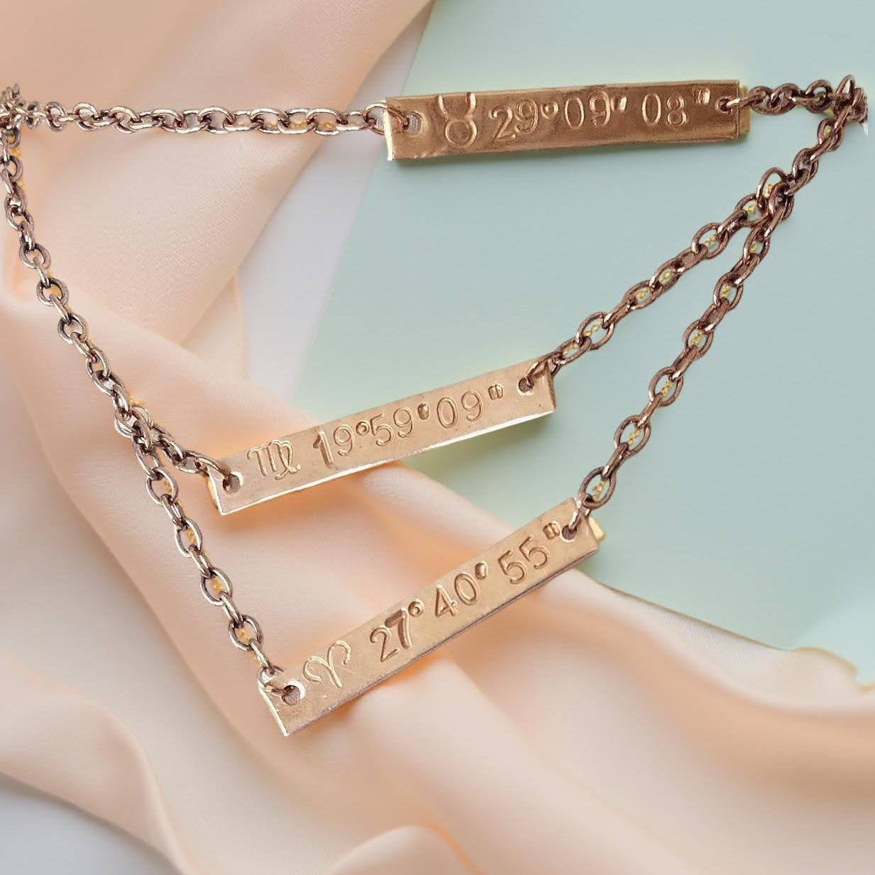 Personalized copper plaques 1 1/2 X 1/4th inch hand stamped zodiac sun sign and the degree of the sun at birth. With options of additional plaques for other family members or friends on a 16 inch, 18 inch and 20 inch (ect) multi chained single necklace.