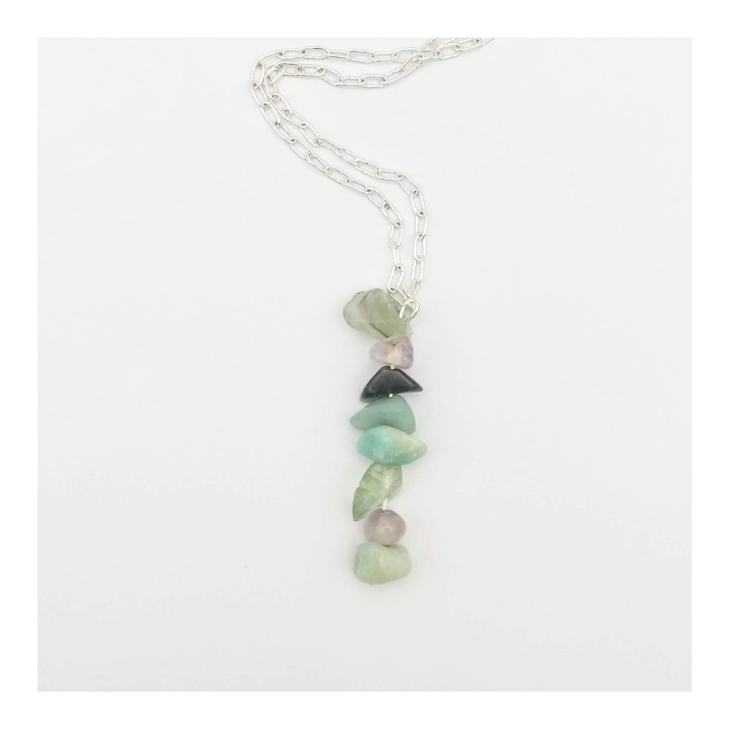 Mercury Retrograde protection necklace has assorted chipped crystals including sodalite, amazonite, blue lace agate, clear quartz, and green fluorite. Hanging on a 20 inch long silver toned chain. With the gemstones a-lined on a 2 1/4 inch drop in a random but complementary order.