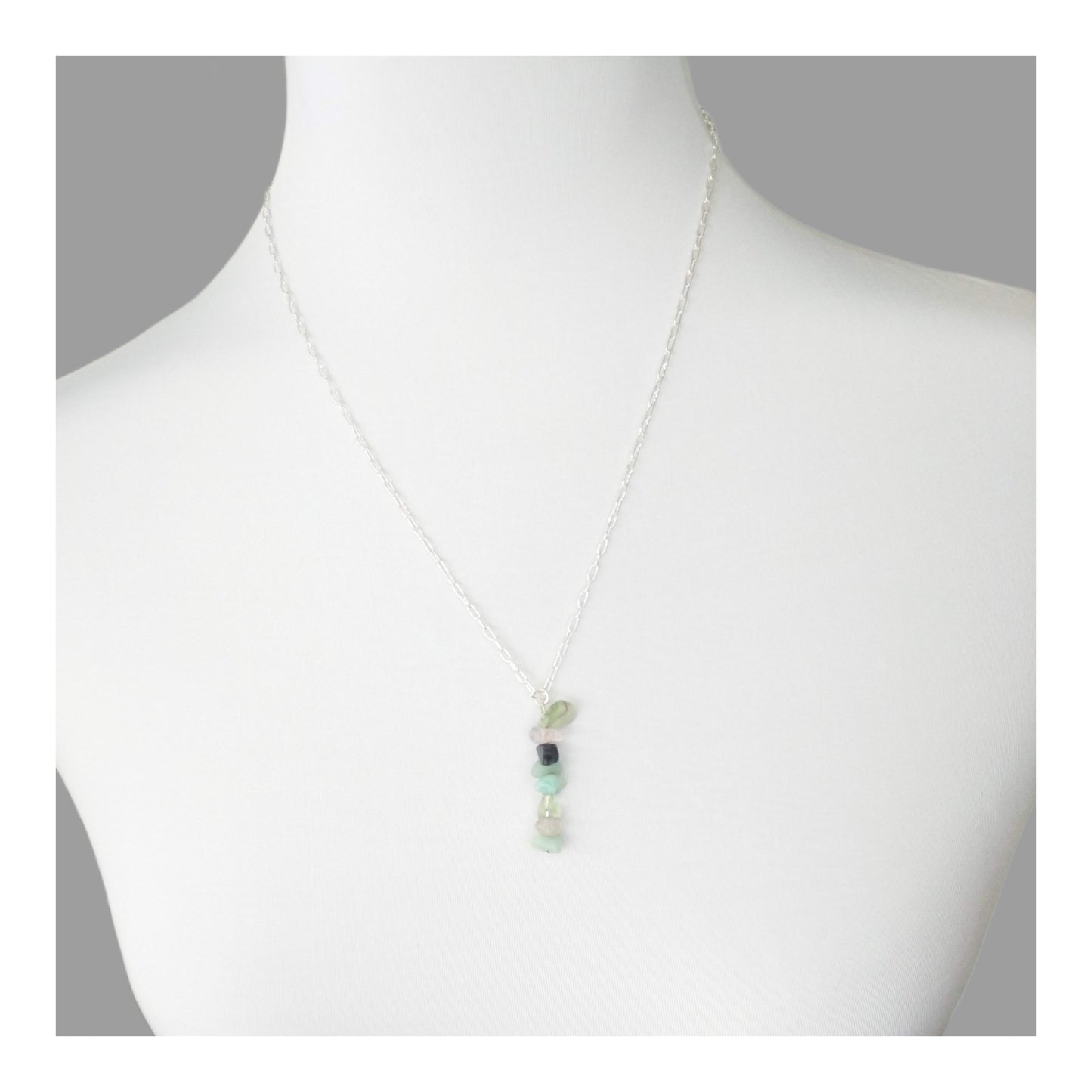 Mercury Retrograde protection necklace has assorted chipped crystals including sodalite, amazonite, blue lace agate, clear quartz, and green fluorite. Hanging on a 20 inch long silver toned chain. With the gemstones a-lined on a 2 1/4 inch drop in a random but complementary order.
